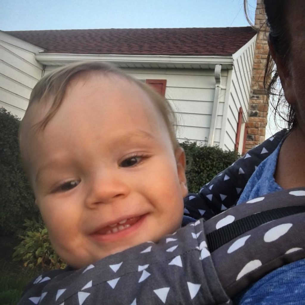 Back carrying Asher in a Tula while he watches Dada work